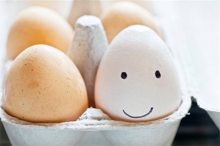 eggs with face - An egg in the carton with a smiley face drawn on it. Stock Photo - Budget Royalty-Free & Subscription, Code: 400-06083533