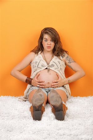 Anxious pregnant woman having contractions while sitting on the floor Stock Photo - Budget Royalty-Free & Subscription, Code: 400-06083881