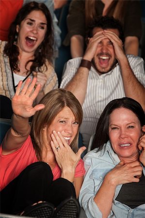 people scared movie theatre - Screaming people curled up in seats at a movie theater Stock Photo - Budget Royalty-Free & Subscription, Code: 400-06083902