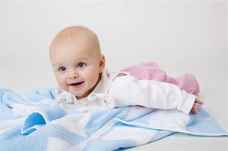 pzromashka (artist) - happy beautiful baby on a blue towel Foto de stock - Royalty-Free Super Valor e Assinatura, Número: 400-06094599