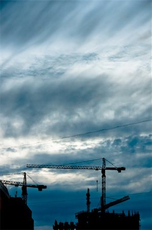 simsearch:400-06075932,k - Small silhouettes of cranes with beautiful and dramatic cloudscape background Fotografie stock - Microstock e Abbonamento, Codice: 400-06094809