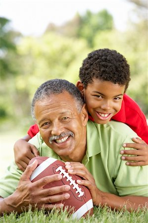 Grandfather With Grandson In Park With American Football Stock Photo - Budget Royalty-Free & Subscription, Code: 400-06095698