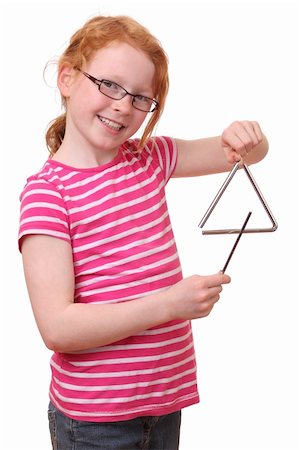 play the triangle - A young girl plays with a triangle Stock Photo - Budget Royalty-Free & Subscription, Code: 400-06095785