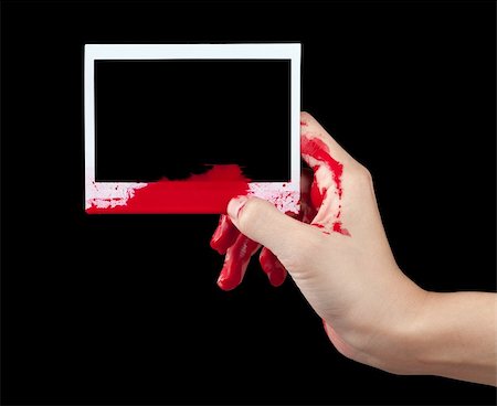 simsearch:400-04075629,k - A blood covered hand holding up a piece of blank instant film isolated on black. Stock Photo - Budget Royalty-Free & Subscription, Code: 400-06097121
