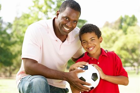 Father And Son In Park With Football Stock Photo - Budget Royalty-Free & Subscription, Code: 400-06097407