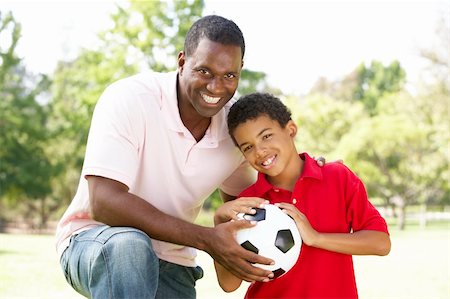 Father And Son In Park With Football Stock Photo - Budget Royalty-Free & Subscription, Code: 400-06097408