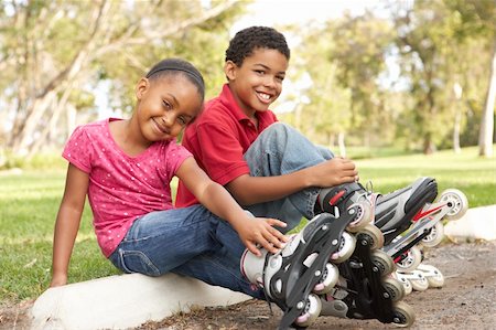 rollerblade girl - Children Putting On In Line Skates In Park Stock Photo - Budget Royalty-Free & Subscription, Code: 400-06097445