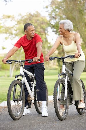 simsearch:400-05735475,k - Senior Couple Riding Bikes In Park Stock Photo - Budget Royalty-Free & Subscription, Code: 400-06097455