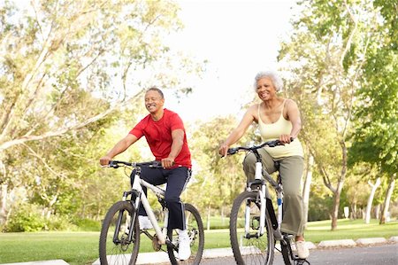 simsearch:400-05735475,k - Senior Couple Riding Bikes In Park Stock Photo - Budget Royalty-Free & Subscription, Code: 400-06097456