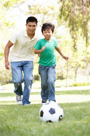 Father And Son In Park With Football Foto de stock - Super Valor sin royalties y Suscripción, Código: 400-06097554