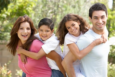 piggyback brothers - Portrait of Happy Family In Park Stock Photo - Budget Royalty-Free & Subscription, Code: 400-06097698