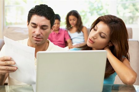 simsearch:400-04044108,k - Parents Using Laptop At Home Stock Photo - Budget Royalty-Free & Subscription, Code: 400-06097727