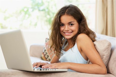 Young Girl Using Laptop At Home Stock Photo - Budget Royalty-Free & Subscription, Code: 400-06097736