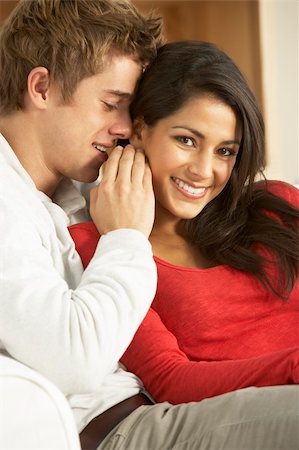 Young Couple Sitting On Sofa Stock Photo - Budget Royalty-Free & Subscription, Code: 400-06098112