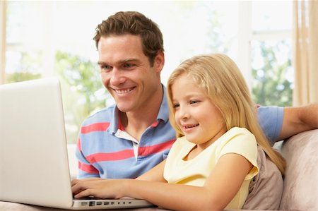 Father And Daughter Using Laptop At Home Stock Photo - Budget Royalty-Free & Subscription, Code: 400-06098322