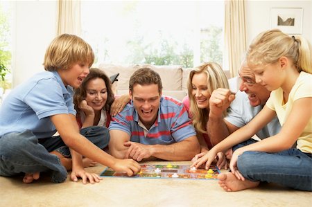 simsearch:400-06098367,k - Family Playing Board Game At Home With Grandparents Watching Stock Photo - Budget Royalty-Free & Subscription, Code: 400-06098364