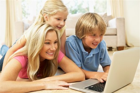 Mother And Children Using Laptop At Home Stock Photo - Budget Royalty-Free & Subscription, Code: 400-06098374