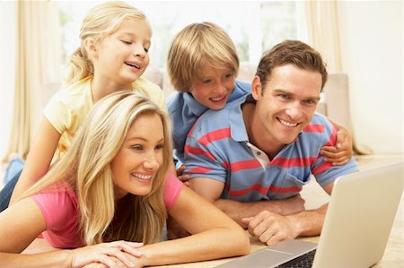 simsearch:400-04044108,k - Family Using Laptop At Home Together Stock Photo - Budget Royalty-Free & Subscription, Code: 400-06098375