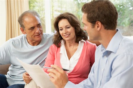 financial advisor talking to couple - Senior Couple With Financial Advisor At Home Foto de stock - Super Valor sin royalties y Suscripción, Código: 400-06098377