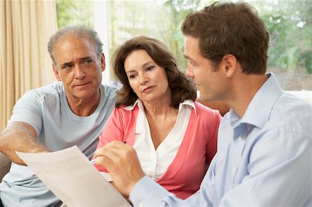 financial advisor talking to couple - Senior Couple With Financial Advisor At Home Foto de stock - Super Valor sin royalties y Suscripción, Código: 400-06098378