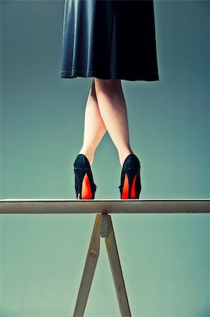 foot concept - slender female legs crossed in the shoes with red soles on the table Stock Photo - Budget Royalty-Free & Subscription, Code: 400-06098515