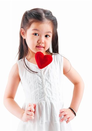 Asian little girl holding a love shape isolated on white background Stock Photo - Budget Royalty-Free & Subscription, Code: 400-06098655