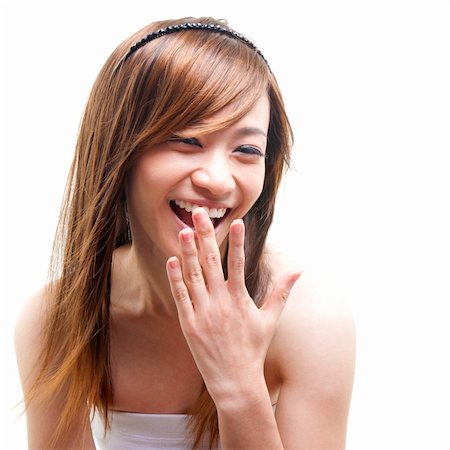 Laughing Asian woman covering her mouth on white background Stock Photo - Budget Royalty-Free & Subscription, Code: 400-06098652