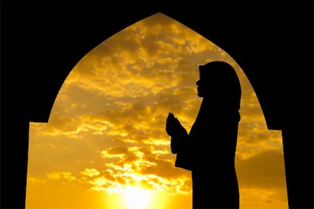 Silhouette of Female Muslim praying in mosque during sunset time Stock Photo - Budget Royalty-Free & Subscription, Code: 400-06098672