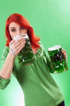 simsearch:400-05091591,k - Photo of a beautiful redhead holding two huge mugs of green beer and drinking from one, on St. Patricks Day. Stock Photo - Budget Royalty-Free & Subscription, Code: 400-06099281