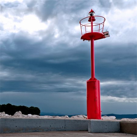 simsearch:400-07407835,k - Red light at the port entrance to the harbor Fotografie stock - Microstock e Abbonamento, Codice: 400-06099535