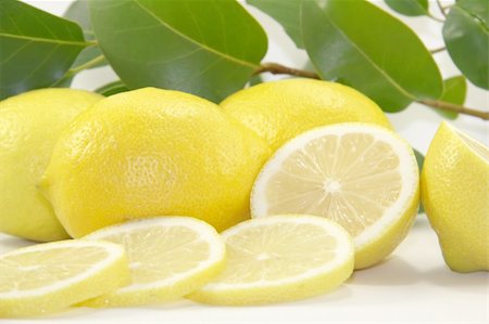 Fresh juicy lemons with leaves on white background Stock Photo - Budget Royalty-Free & Subscription, Code: 400-06099655