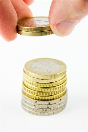 stack of coin sign - Saving money putting some coins on a stack Stock Photo - Budget Royalty-Free & Subscription, Code: 400-06090389