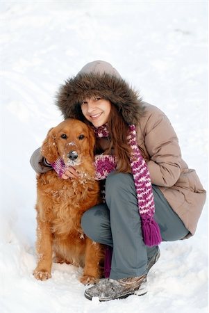emotional golden retriever - smiling teenager caucasian girl in hood hugging her dog outdoors at snow Stock Photo - Budget Royalty-Free & Subscription, Code: 400-06090426