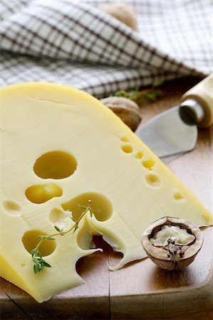 emmental - large piece of cheese varieties Maasdam on cutting board Fotografie stock - Microstock e Abbonamento, Codice: 400-06091266