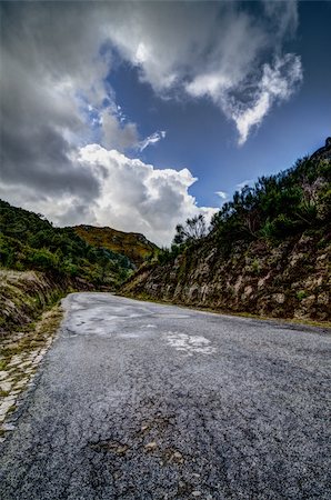 simsearch:400-07524978,k - Asphalt road in the mountains and blue sky with clouds. Photographie de stock - Aubaine LD & Abonnement, Code: 400-06091384