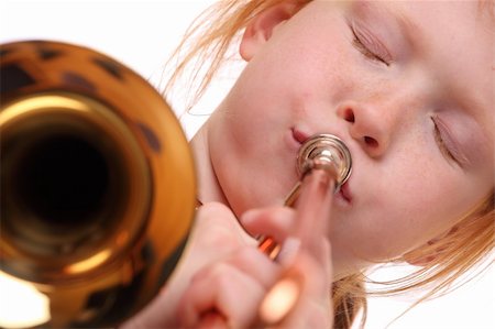 Young girl playing a trombone on white background Stock Photo - Budget Royalty-Free & Subscription, Code: 400-06092008