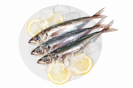 Three raw mackerel in ice and lemon. On a white background. Stock Photo - Budget Royalty-Free & Subscription, Code: 400-06092280