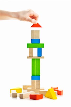 Hand building tower of wooden blocks isolated on white background Stock Photo - Budget Royalty-Free & Subscription, Code: 400-06092298