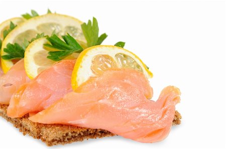 Sandwich snack - salmon with lemon on rye bread. Isolated on white. Stockbilder - Microstock & Abonnement, Bildnummer: 400-06092480