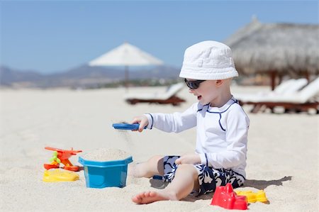 adorable smiling toddler playing at the tropical beach Stock Photo - Budget Royalty-Free & Subscription, Code: 400-06092617