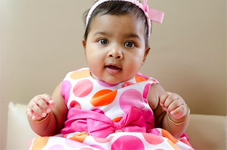 simsearch:400-05739745,k - Adorable 6 months old Indian baby girl sitting on sofa Stock Photo - Budget Royalty-Free & Subscription, Code: 400-06092798