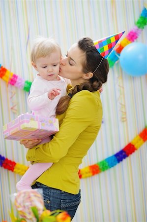 simsearch:400-06076022,k - Mother kissing baby on birthday celebration party Photographie de stock - Aubaine LD & Abonnement, Code: 400-06093159