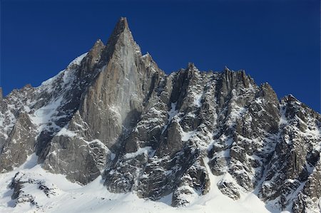 Image of the westface of the Petit Dru summit (3733m) in Mont Blanc Massif. This summit together with the Grand Dru (3754m) form the Aiguille du Dru which is an iconic summit in this massif. Stock Photo - Budget Royalty-Free & Subscription, Code: 400-06093387