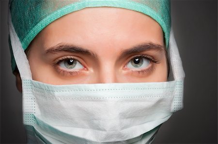 dr in surgical uniform - Closeup portrait of a female surgeon, with face mask, in a dark grey background Stock Photo - Budget Royalty-Free & Subscription, Code: 400-06104070