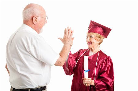 Senior woman graduating from high school gets a high five from her husband.  Isolated on white. Stock Photo - Budget Royalty-Free & Subscription, Code: 400-06104530
