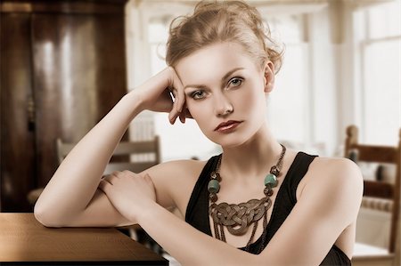 fashion shot of blond cute woman in elegant black dress and necklace jewellery Stock Photo - Budget Royalty-Free & Subscription, Code: 400-06104638