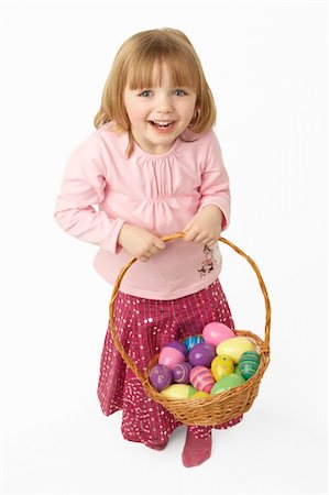 eggs with face - Young Girl Carrying Basket Filled With Easter Eggs Stock Photo - Budget Royalty-Free & Subscription, Code: 400-06105058