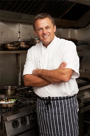 simsearch:400-06105151,k - Male Chef Standing Next To Cooker In Restaurant Kitchen Foto de stock - Super Valor sin royalties y Suscripción, Código: 400-06105172