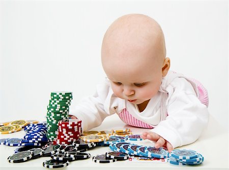 Lying on the table baby girl playing casino chips Stock Photo - Budget Royalty-Free & Subscription, Code: 400-06106054