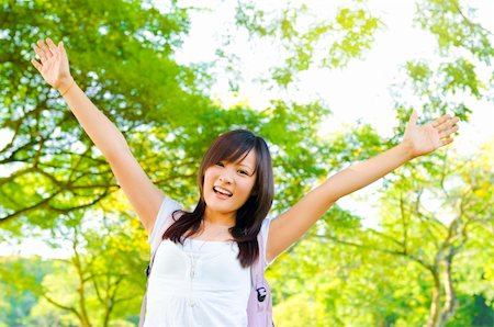 simsearch:400-04982004,k - Excited Asian teen raise her arms in university campus Stock Photo - Budget Royalty-Free & Subscription, Code: 400-06107328